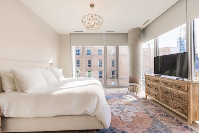 bedroom with visible vents and a chandelier