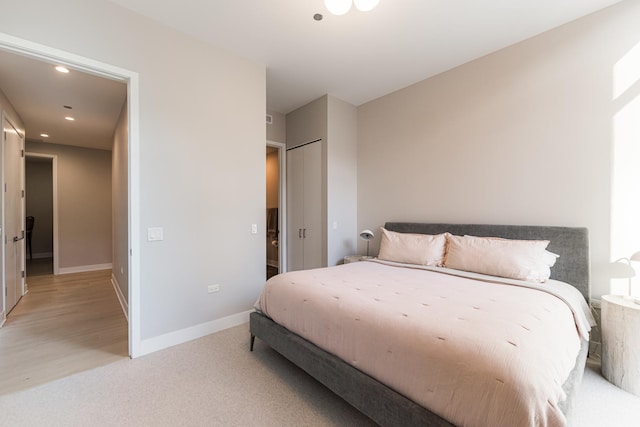 bedroom with recessed lighting, baseboards, and light carpet