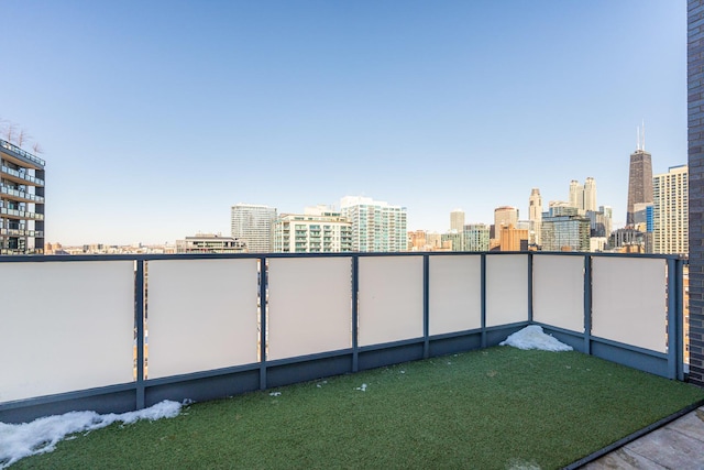 view of yard featuring a balcony and a city view