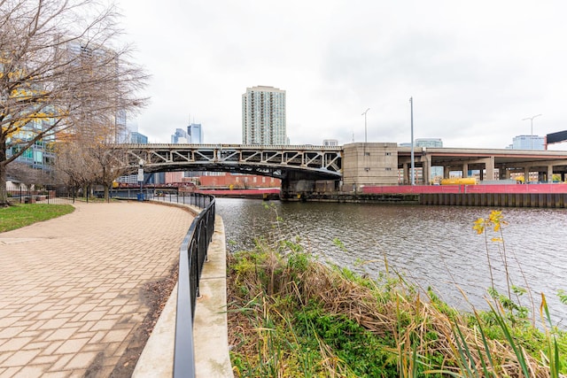 exterior space with a city view, a pier, and a water view