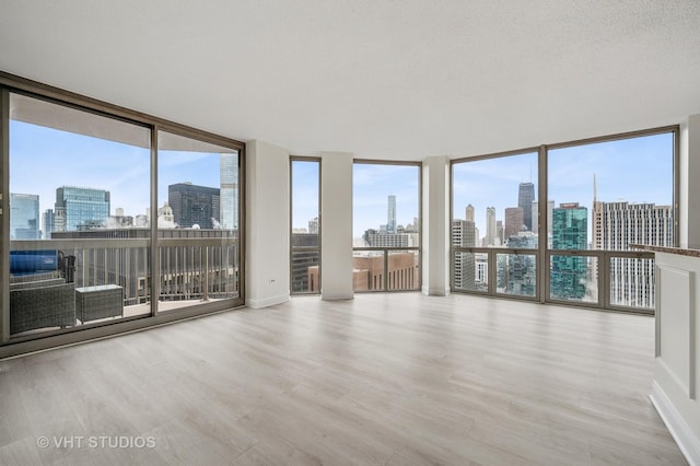 unfurnished sunroom featuring a view of city and plenty of natural light