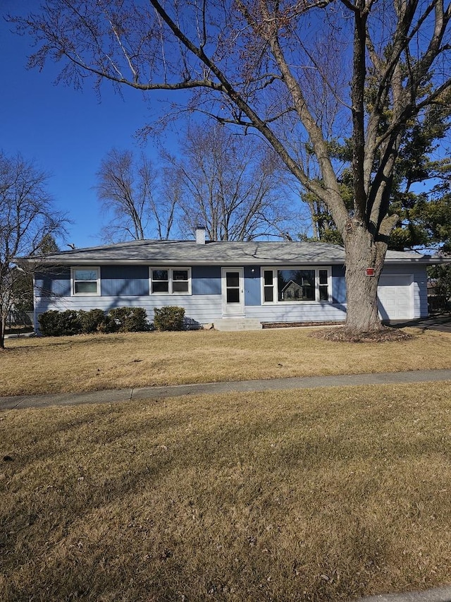 single story home featuring a front yard, a garage, and a chimney