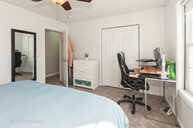 bedroom featuring a ceiling fan, carpet, a closet, and baseboards