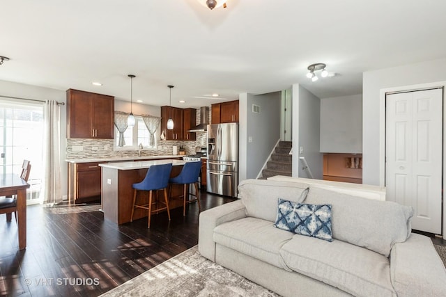 living area featuring stairs, recessed lighting, visible vents, and dark wood-style flooring