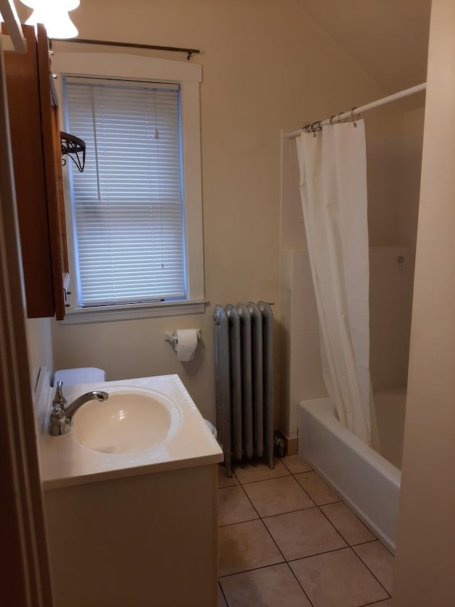 bathroom featuring tile patterned floors, vanity, shower / tub combo with curtain, and radiator heating unit