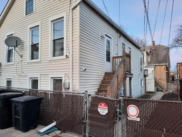 view of side of property featuring a gate and a fenced front yard