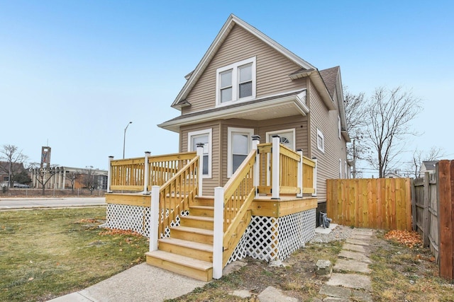 view of front facade featuring a wooden deck and fence