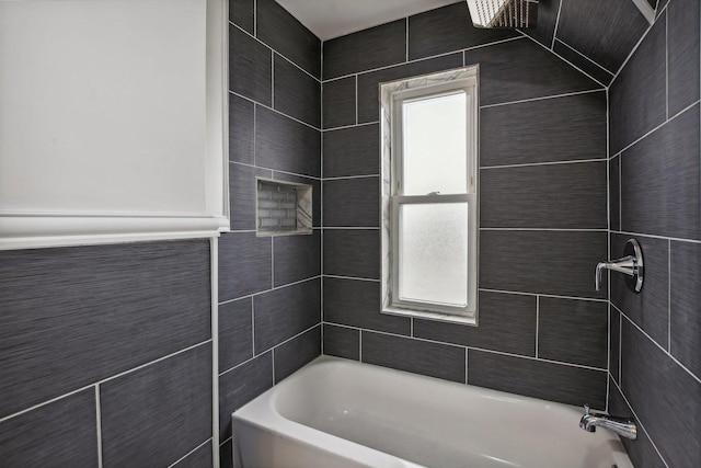 bathroom featuring tile walls and shower / bathing tub combination