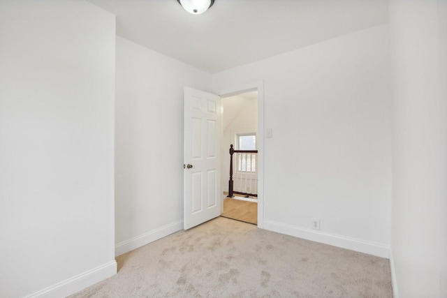 empty room with baseboards and carpet flooring