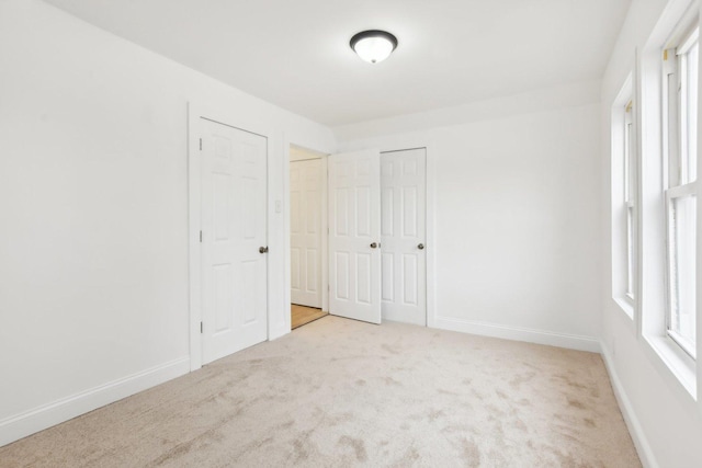 carpeted spare room with baseboards