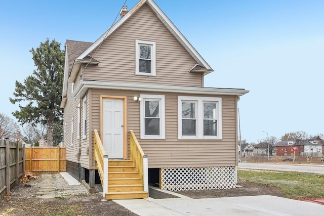 back of house featuring entry steps and fence