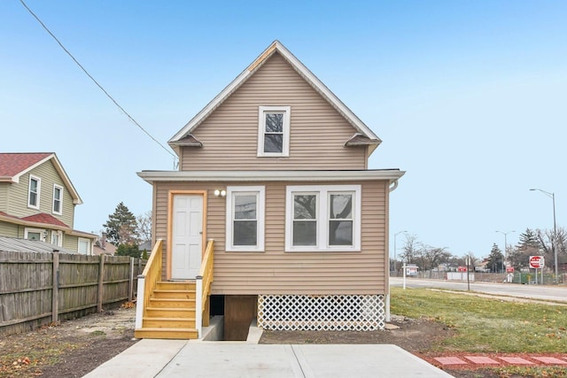 view of front of house featuring entry steps and fence