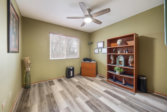 office space with light wood-style floors, baseboards, and ceiling fan