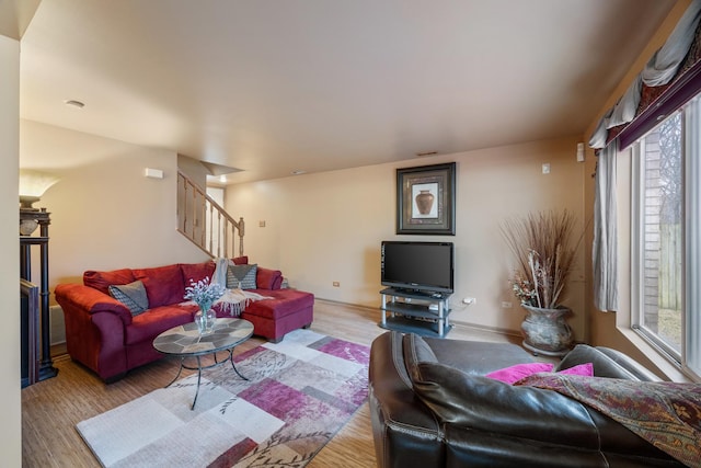 living area with stairway and wood finished floors