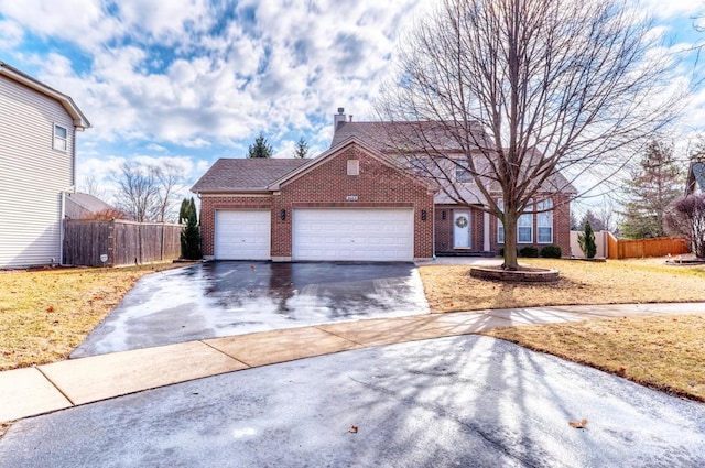 view of front facade featuring fence, driveway, a chimney, a garage, and brick siding