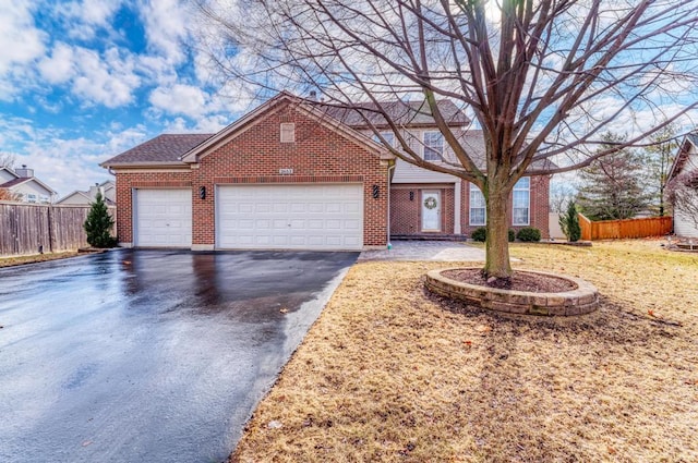 view of front of property with aphalt driveway, brick siding, an attached garage, and fence