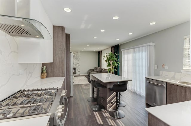 kitchen featuring stainless steel appliances, tasteful backsplash, modern cabinets, and dark wood-style floors