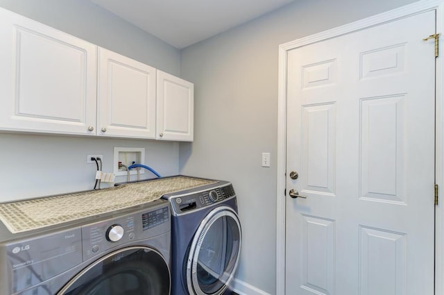 washroom with washing machine and clothes dryer, cabinet space, and baseboards