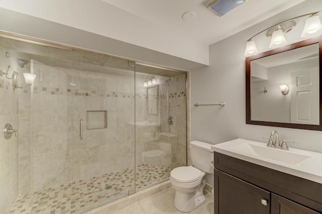 bathroom with tile patterned floors, toilet, a stall shower, and vanity