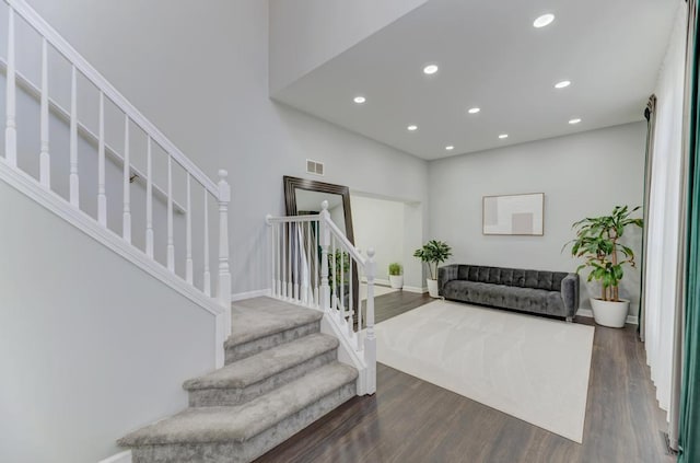 stairs featuring visible vents, recessed lighting, and wood finished floors