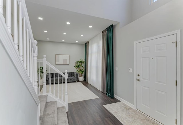 foyer entrance with recessed lighting, stairway, baseboards, and dark wood-style floors