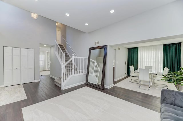 foyer entrance with visible vents, a healthy amount of sunlight, stairway, recessed lighting, and wood finished floors