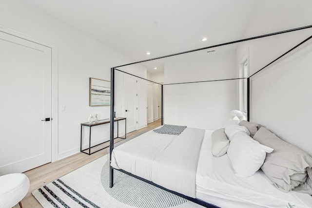 bedroom with recessed lighting and light wood-style floors