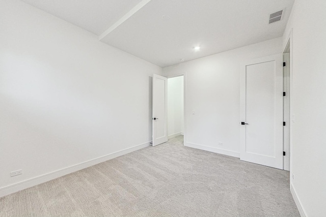 interior space featuring recessed lighting, light colored carpet, visible vents, and baseboards