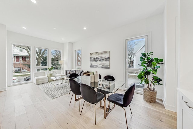 dining room with recessed lighting, baseboards, and light wood-style floors