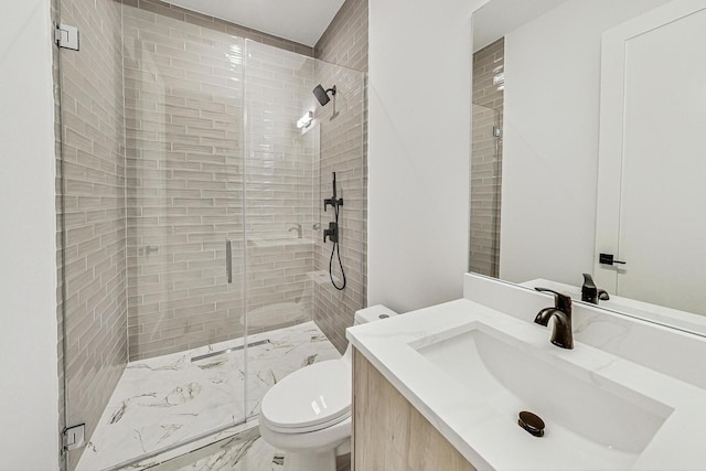 full bathroom featuring toilet, marble finish floor, a stall shower, and vanity