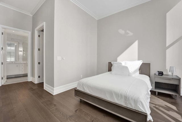 bedroom with crown molding, wood finished floors, baseboards, and ensuite bathroom