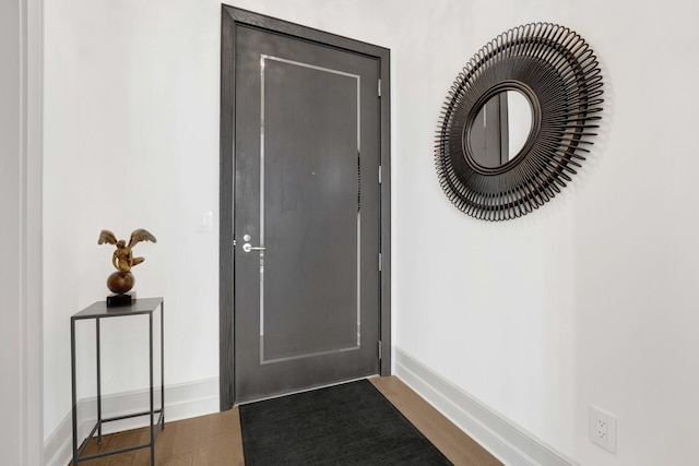 doorway to outside with baseboards