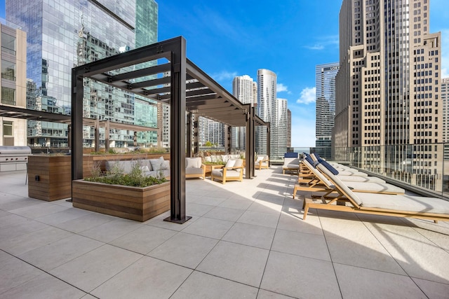 view of patio / terrace with area for grilling, a view of city, and outdoor lounge area