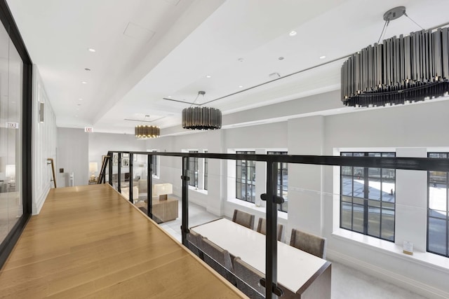 corridor featuring recessed lighting, wood finished floors, and baseboards