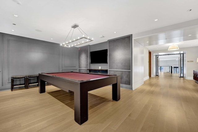 rec room with billiards, a decorative wall, recessed lighting, and light wood-type flooring