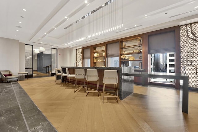 bar featuring wet bar, hanging light fixtures, recessed lighting, and light wood finished floors