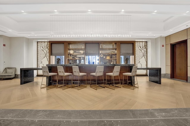 bar featuring indoor wet bar, recessed lighting, and a raised ceiling