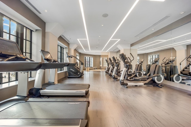 gym with a wealth of natural light and wood finished floors