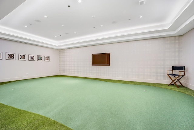 unfurnished room featuring baseboards, a raised ceiling, and carpet flooring