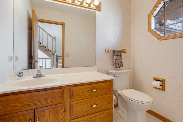 bathroom with tile patterned floors, toilet, wallpapered walls, and vanity