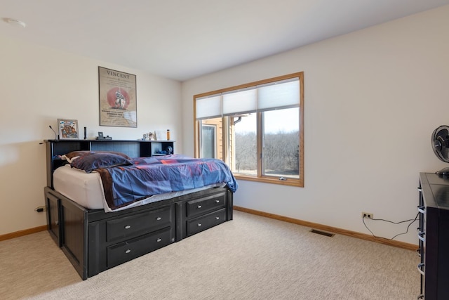 carpeted bedroom featuring baseboards and visible vents