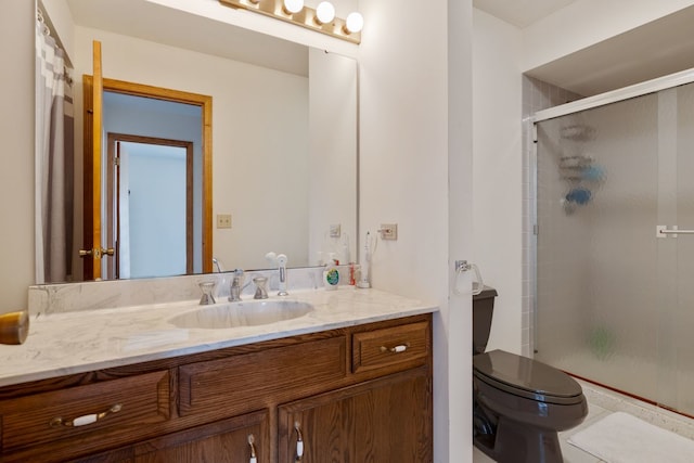 bathroom featuring toilet, a stall shower, and vanity