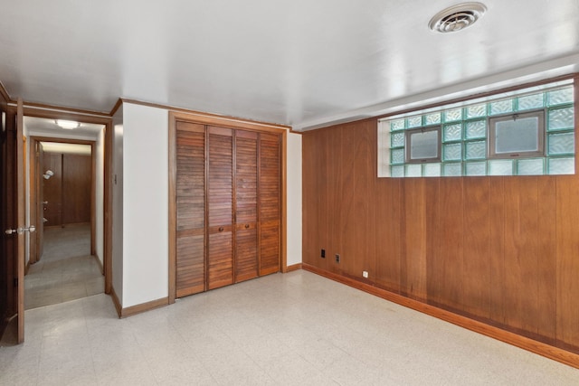 unfurnished bedroom with tile patterned floors, baseboards, a closet, and visible vents