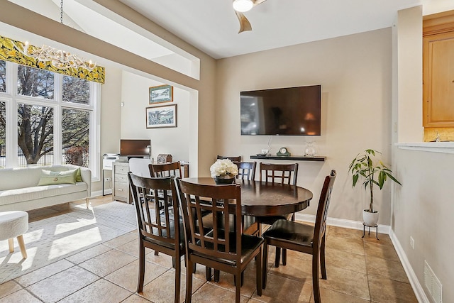 dining room featuring light tile patterned floors, visible vents, and baseboards