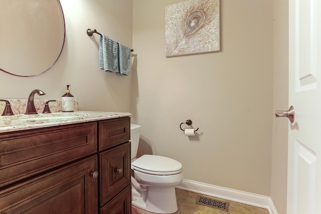 bathroom with visible vents, baseboards, toilet, tile patterned floors, and vanity