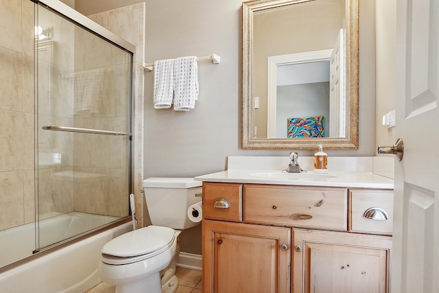 bathroom with vanity, toilet, and combined bath / shower with glass door