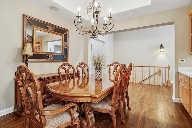 dining area with wood finished floors, baseboards, and a chandelier