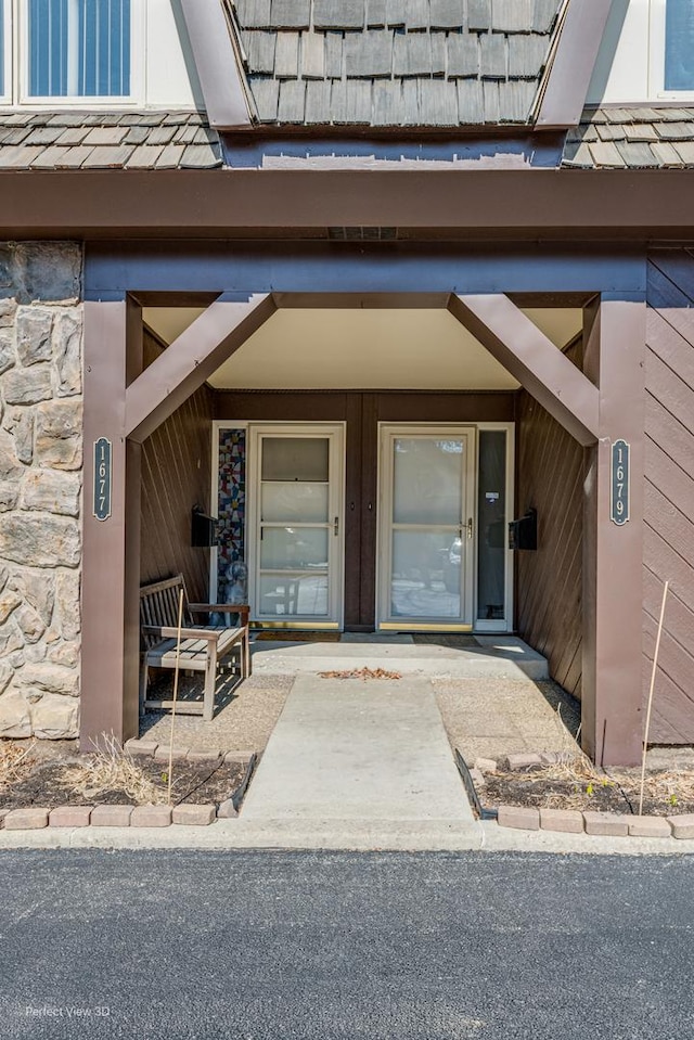 property entrance featuring stone siding and a porch