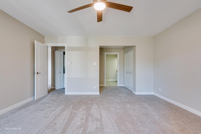 unfurnished bedroom featuring baseboards, carpet, and a ceiling fan