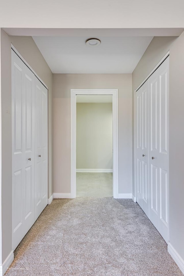 unfurnished bedroom featuring carpet flooring and baseboards